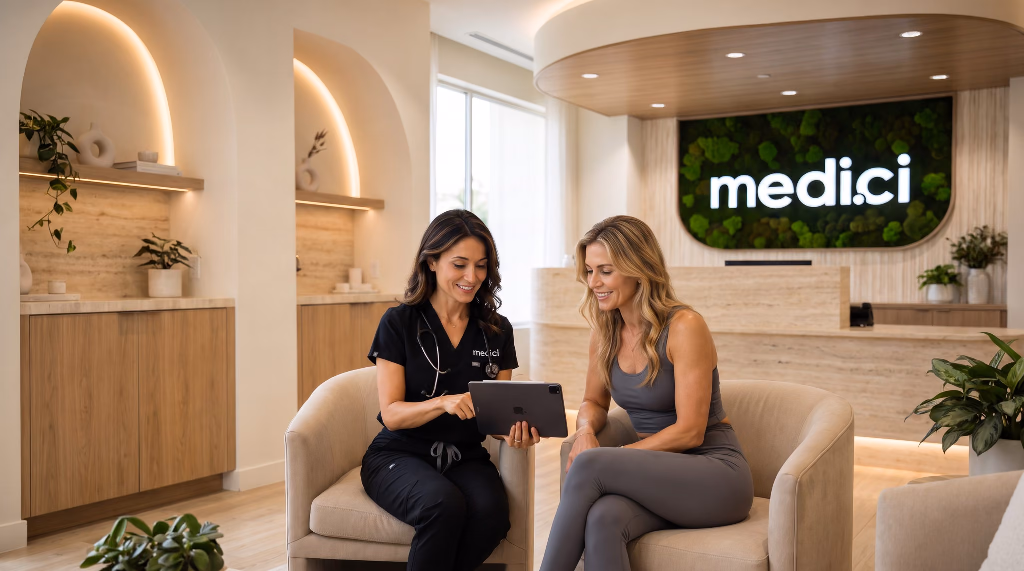 A Medici clinician and a patient looking at a tablet together in a Medici clinic